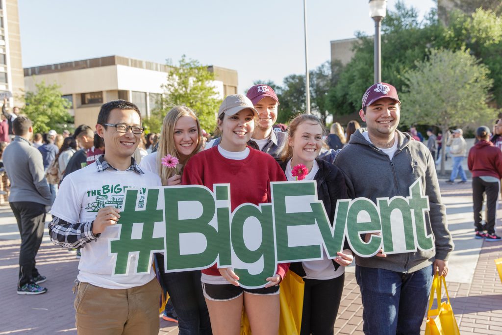 Students hold up a #BigEvent sign at The Big Event kick-off