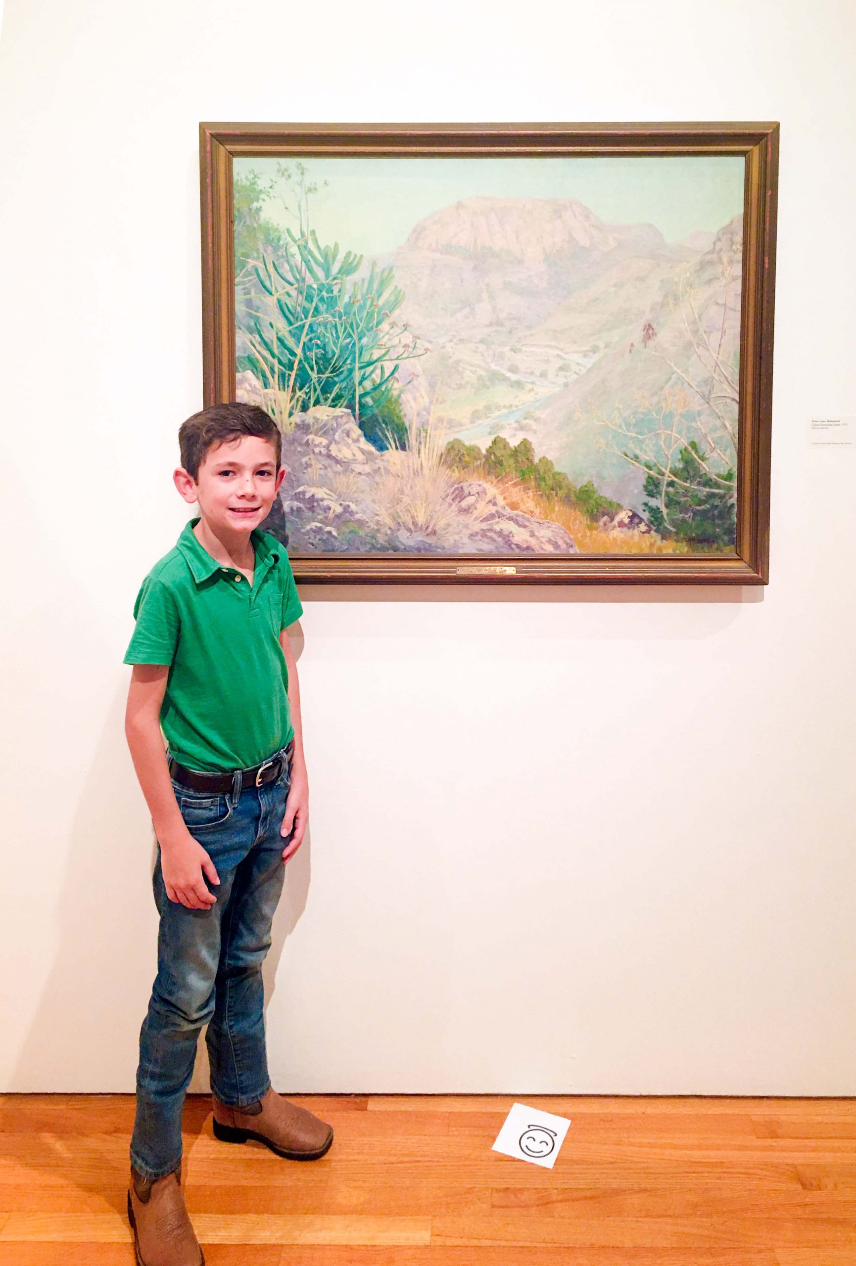 Young child standing in front of a painting at the university art galleries