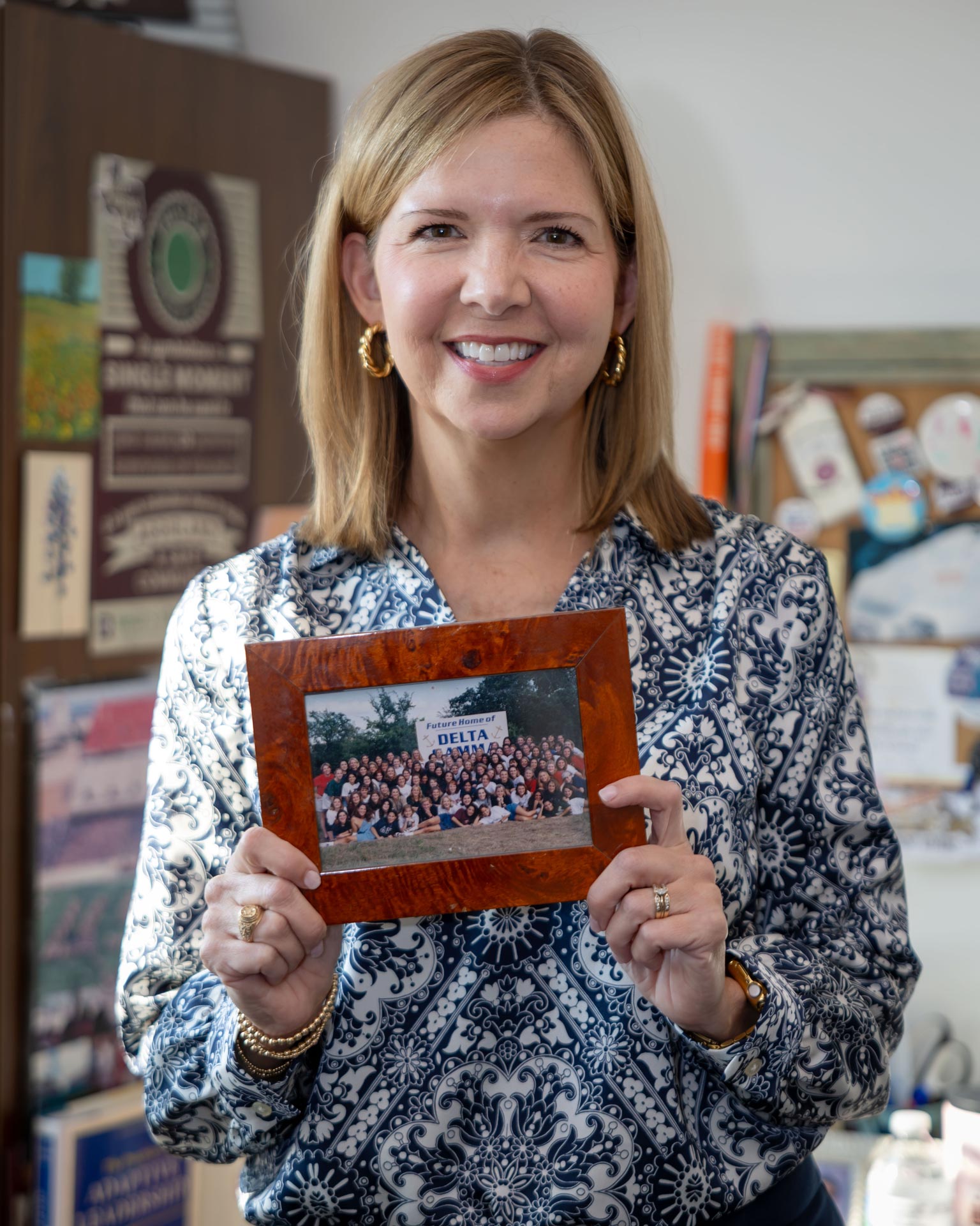 Jennifer Ford with a photograph of the first group of students she served at Texas A&M.