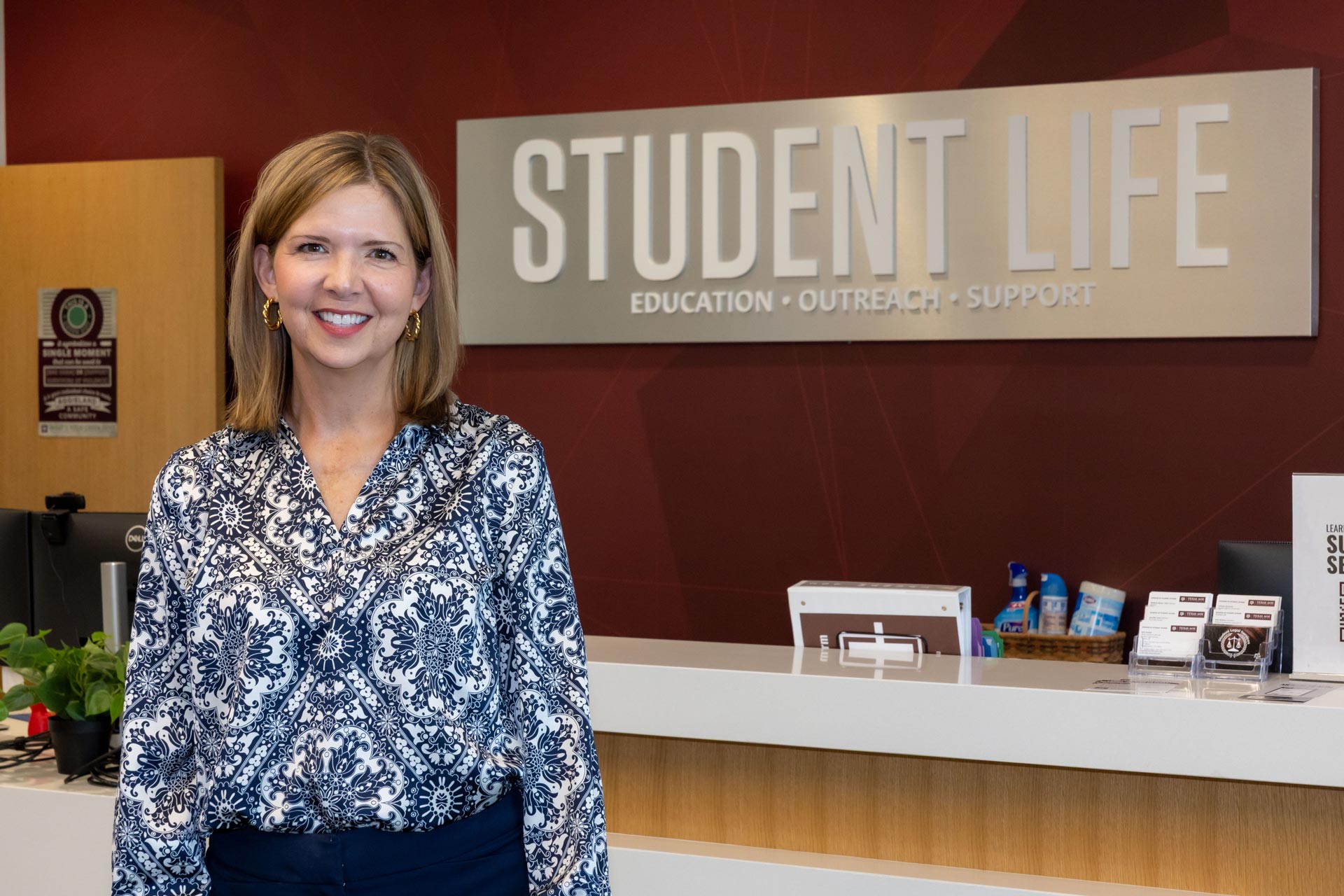 Jennifer Ford standing in the Student Life Director's Office lobby