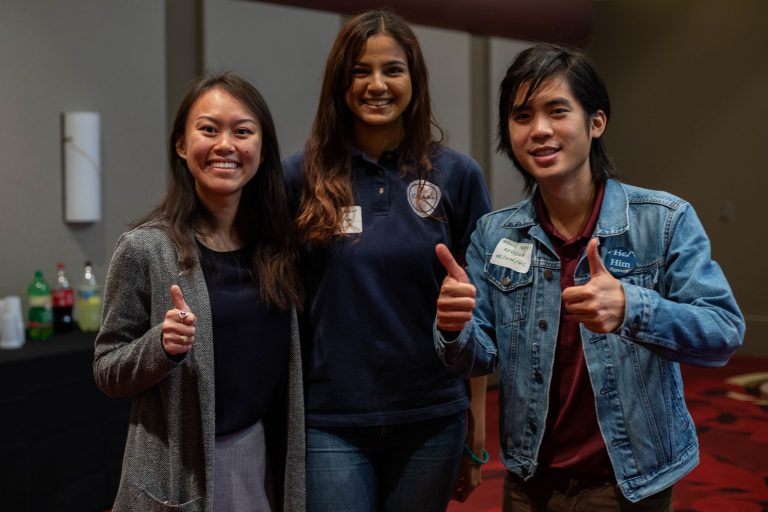 Three students of different backgrounds together at the 30th Anniversary for the Department of Multicultural Services.