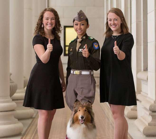 Image of three female students posing with Reveille 