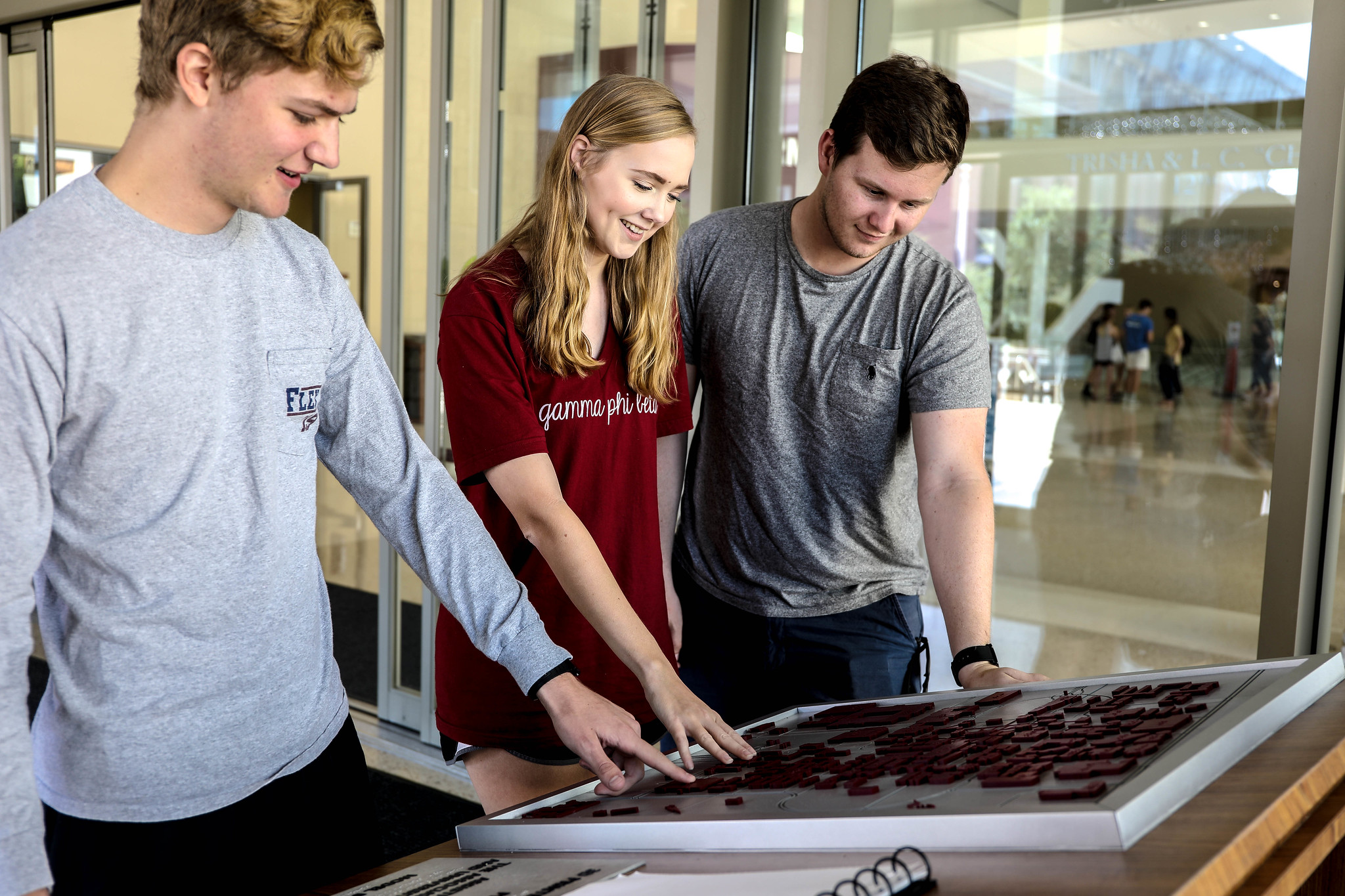 Image of students touching a Braille map of the MSC.