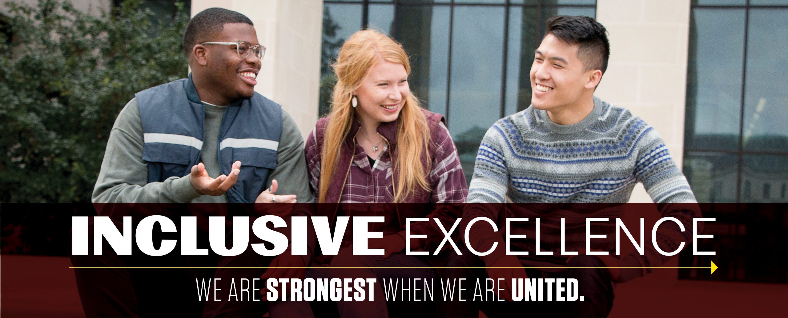 Group of three students laughing together with a graphic displayed over that reads "Inclusive Excellence; We are strongest when we are united." 