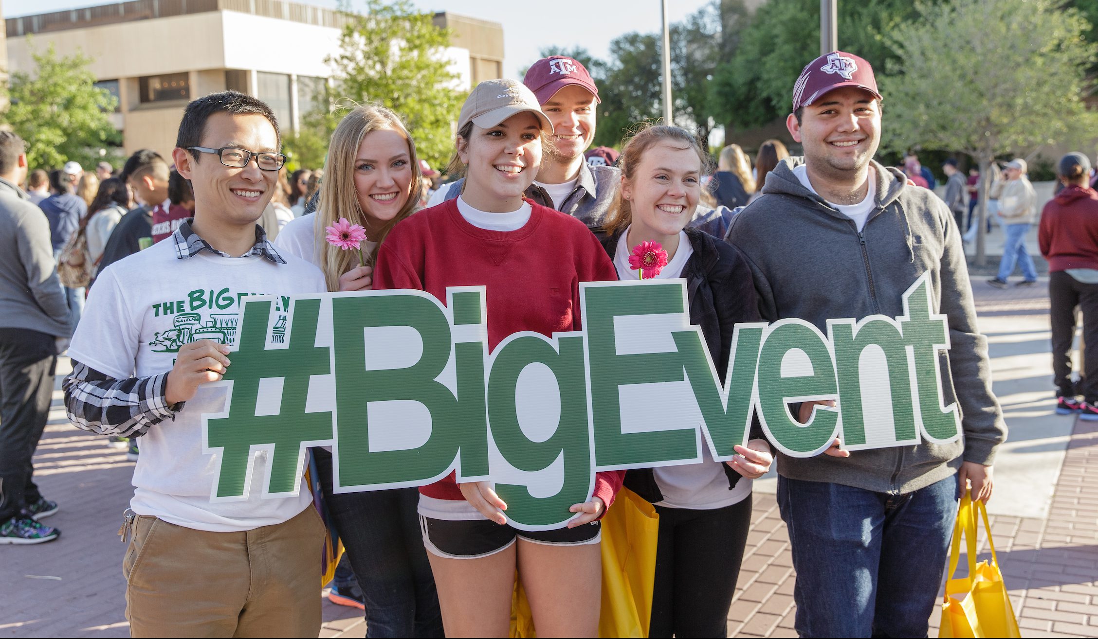 Image of a group of students holding a sign that reads "#BigEvent"