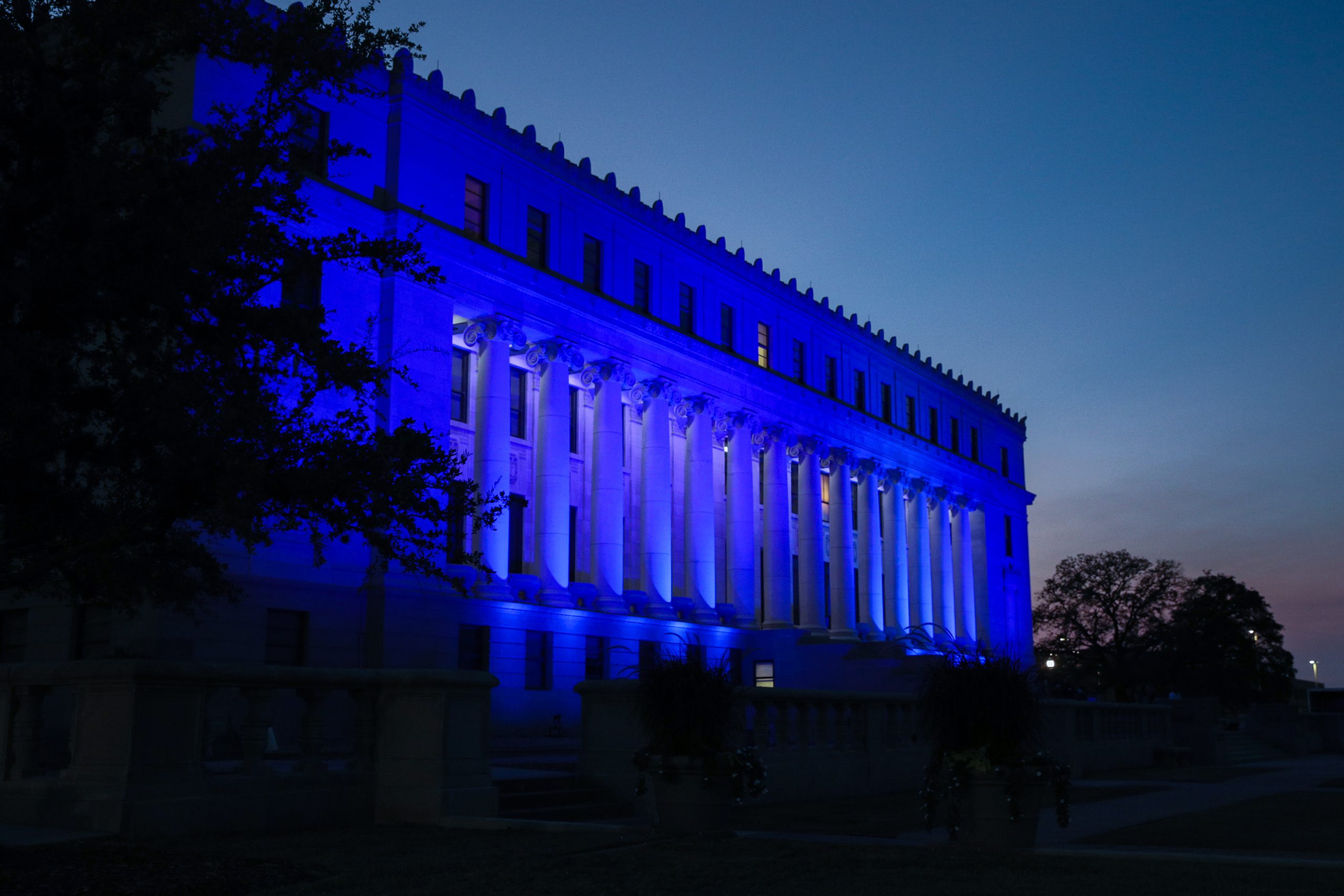 Photo of blue lighting on four buildings on main campus and two buildings at the Health Science Center in blue in support of teachers worldwide.