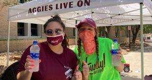 two ResLife staff members wearing masks pose for a photo during Howdy week. 