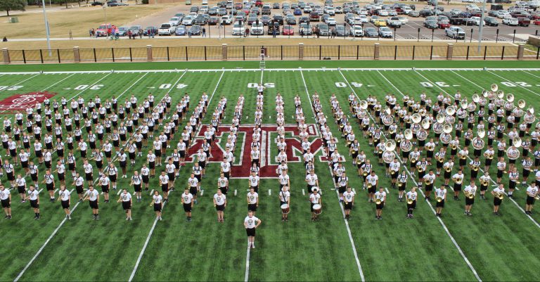 The Fightin' Texas Aggie Band stands in formation on the Dunlap Drill Field during practice.