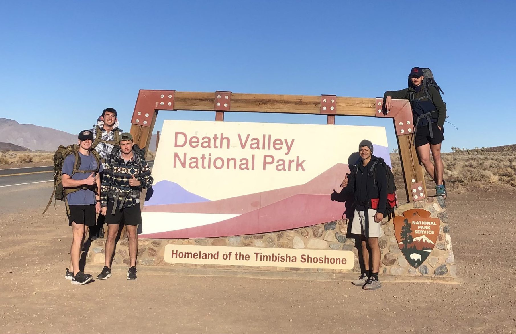 Cadets in the Project Atlas Ruck take a photo in front of the Death Valley National Park sign