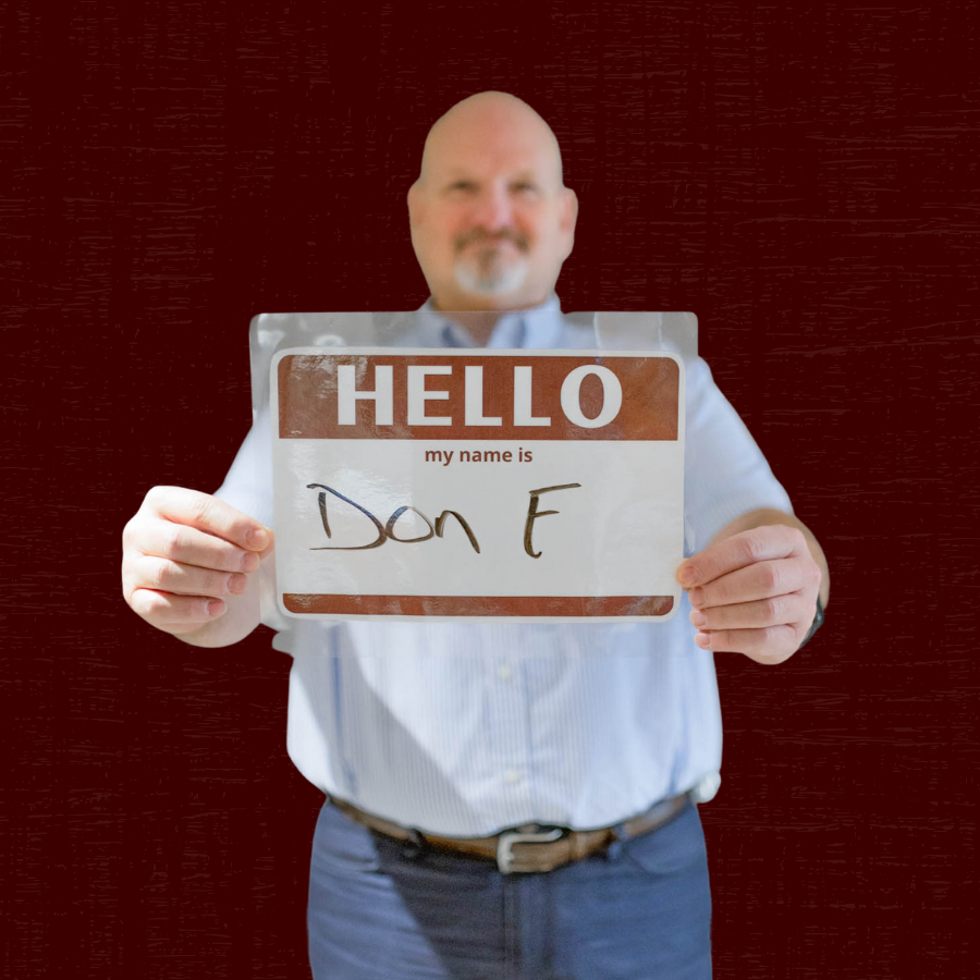 Don Freeman holding a sign saying "Hello my name is Don F."