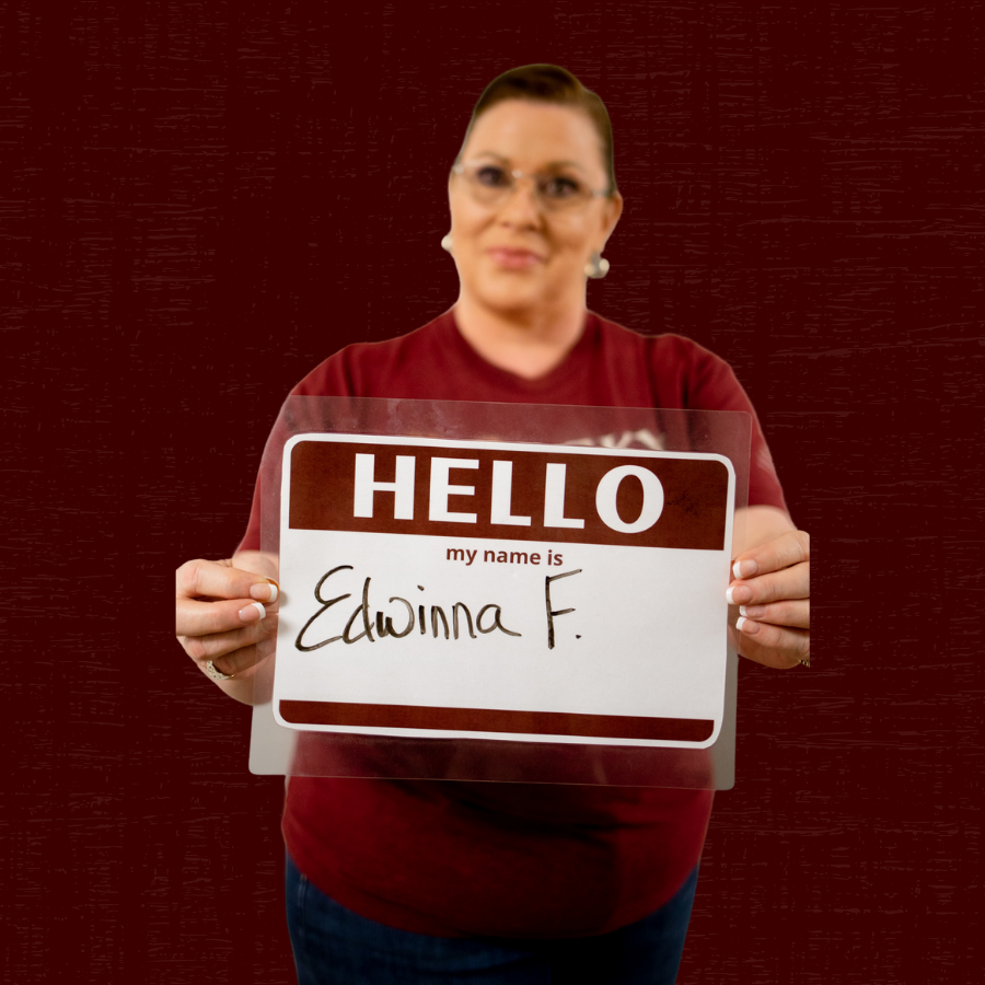 Edwina Ferguson holding a sign saying "Hello my name is Edwina F."
