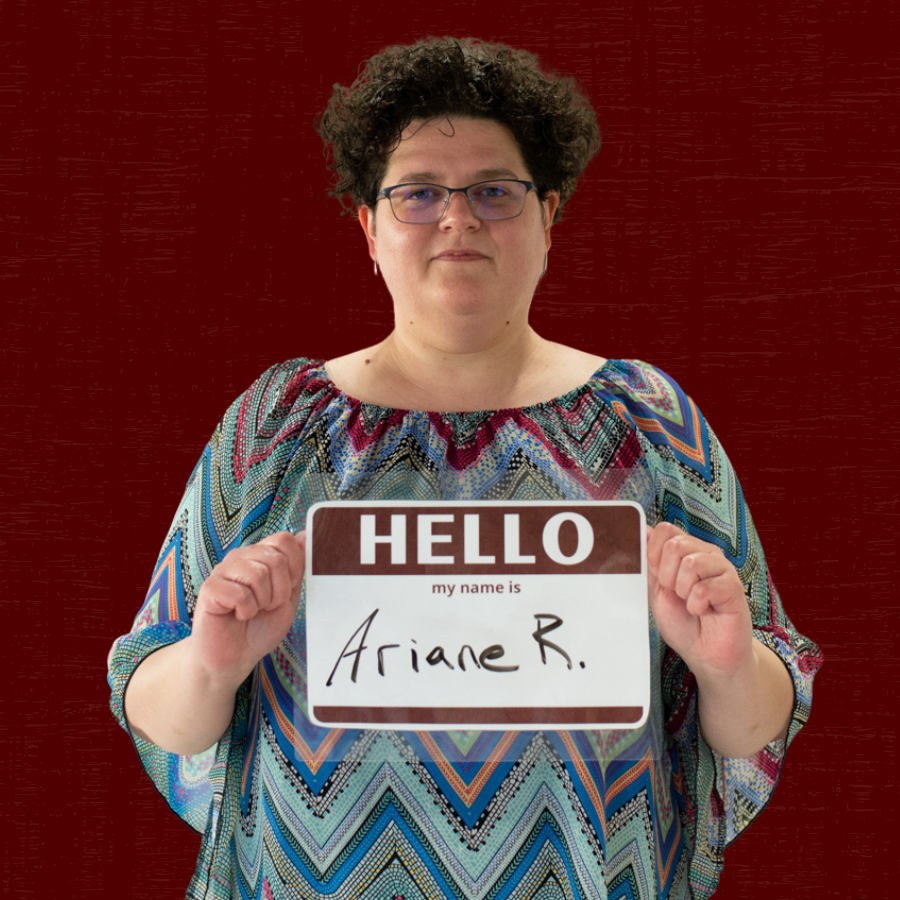 Photo of Ariane Ray holding a sign that says, "Hello my name is Ariane R."