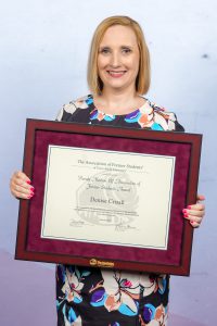 Photo of Dr. Denise Crisafi holding her DSA Award