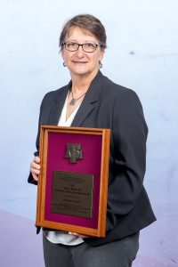 Photo of Dr. Karen Cornell holding her DSA Award