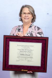 Photo of Debbie Almand holding her DSA Award