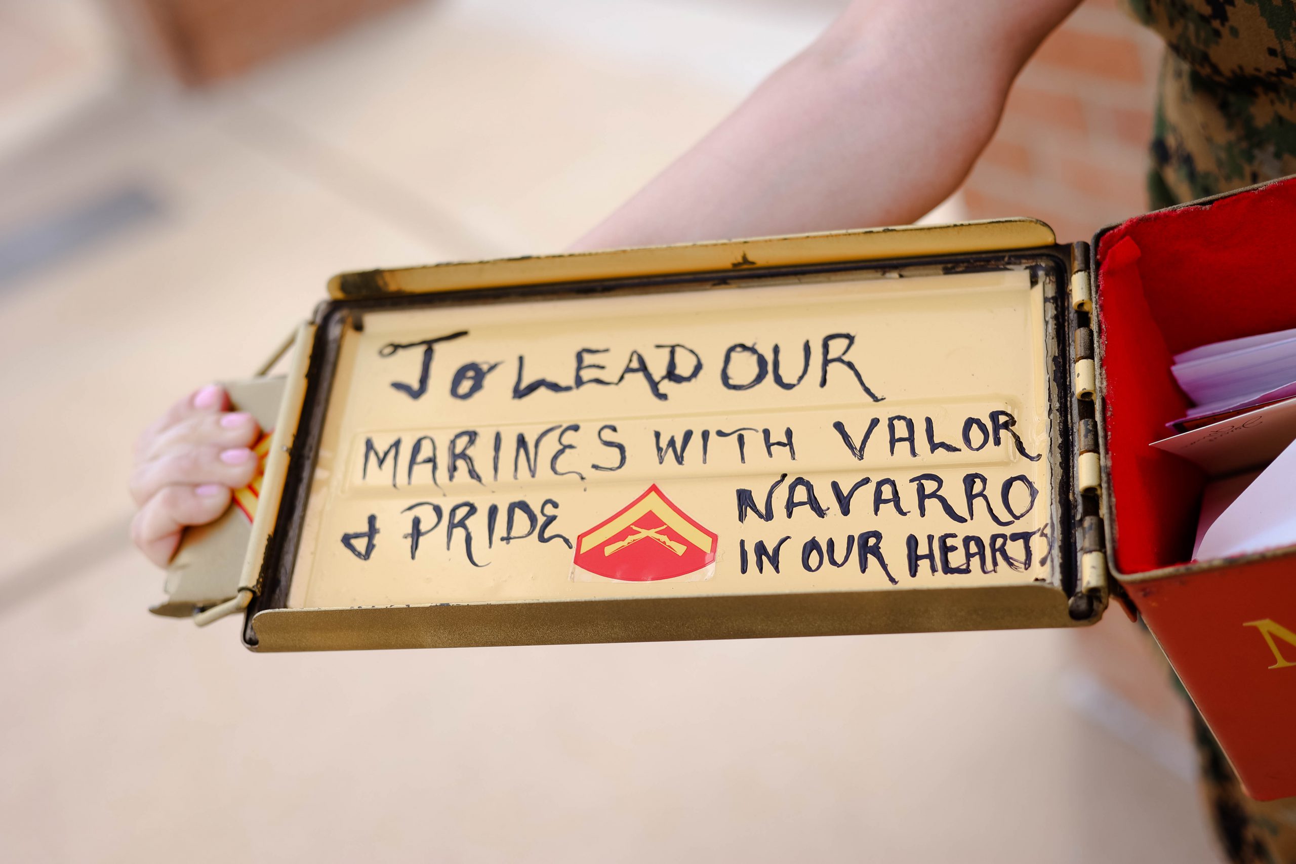 photo of the inside of desiree ornelaz's box that reads "To lead our marines with valor and pride. Navarro in our hearts."