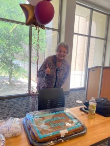 Dr. Carol Binzer with a cake celebrating her selection as the 2023 Hullabaloo U Instructor of the Year.