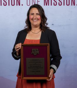 Photo of Carly Smith holding their DSA Award.