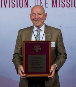 Photo of Jimmie Rogers holding their DSA Award.