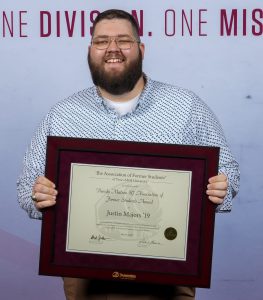 Photo of Justin Majors holding their DSA Award.