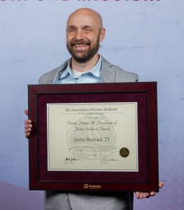 Photo of Justin Romack holding their DSA Award.