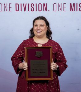 Photo of Katie Campbell holding their DSA Award.