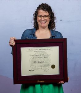 Photo of Libby Daggers holding their DSA Award.