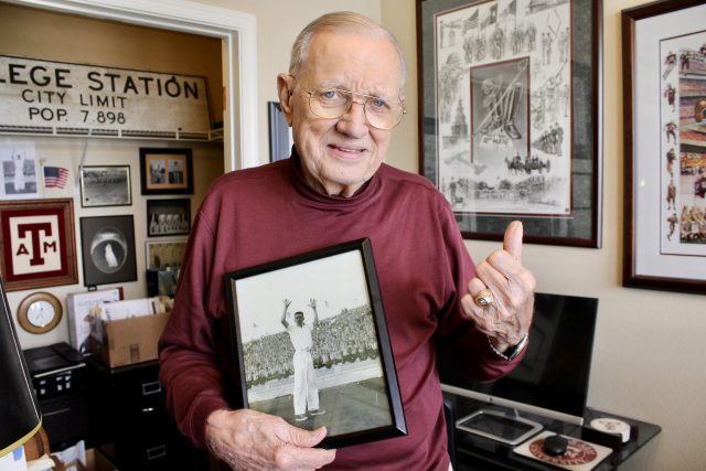 Jimmy Tyree holding a photo of himself as a Yell Leader.
