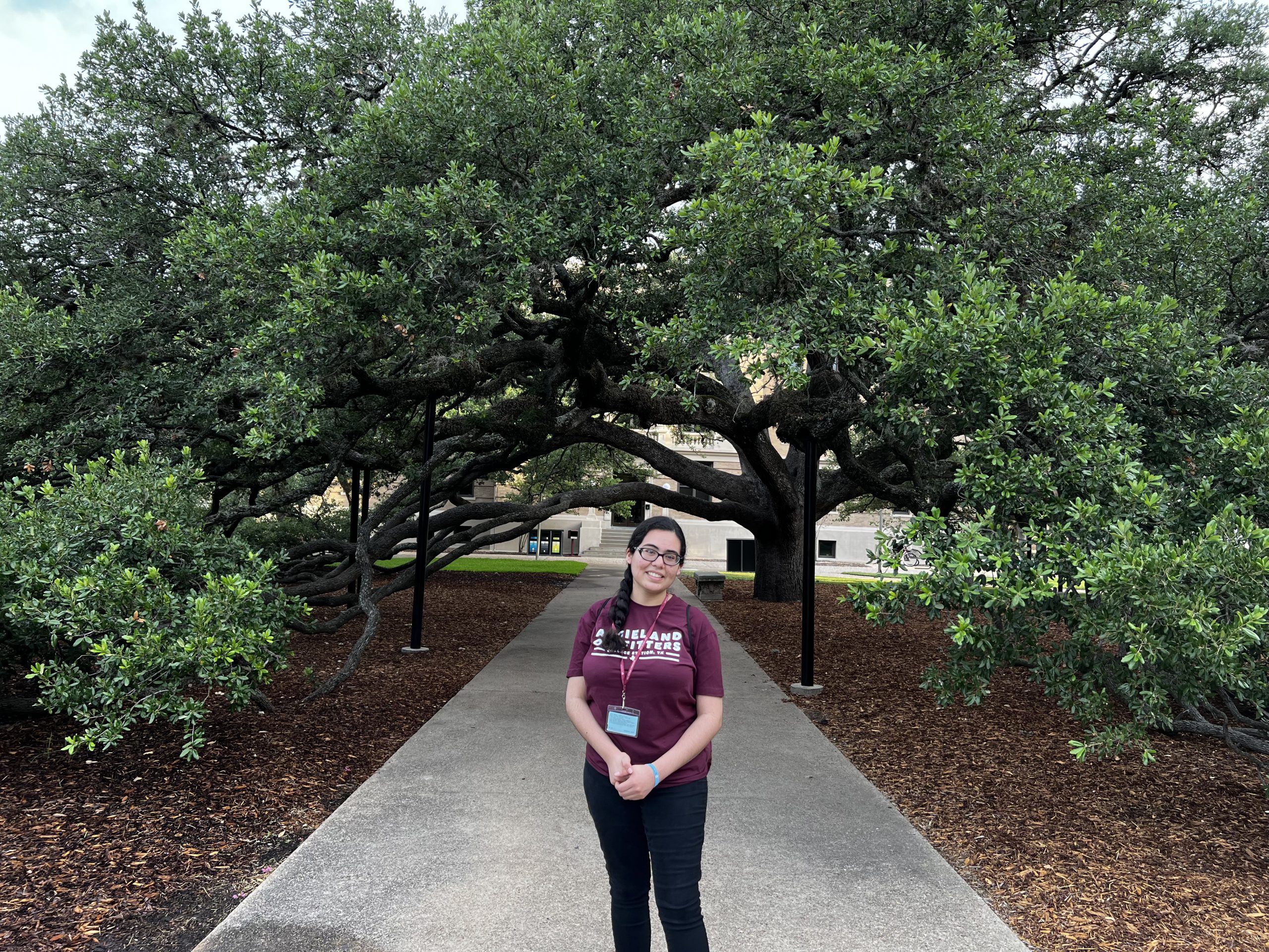 Sophia Garza standing in front of the Century Tree on the Texas A&M Campus