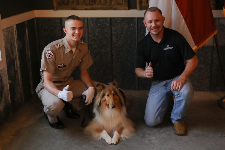 Student Veteran poses with Reveille and her handler