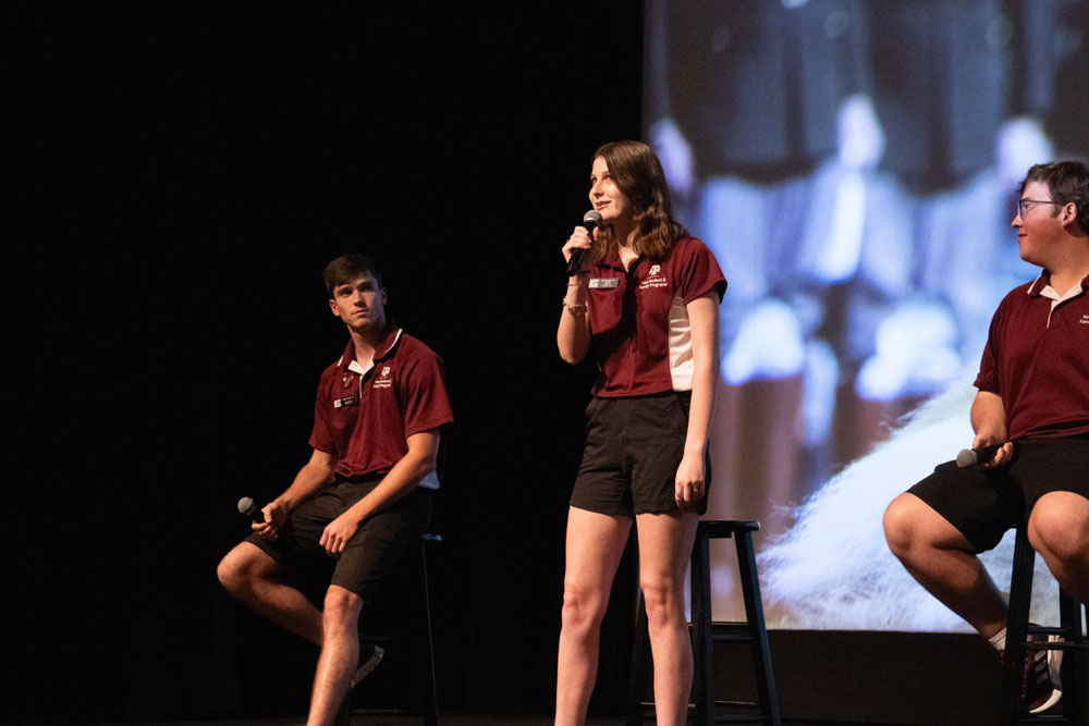 An orientation leader speaking on stage at New Student Conferences