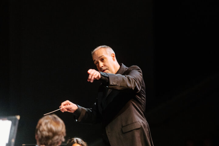 Dr. Tim Rhea conducting at a concert.