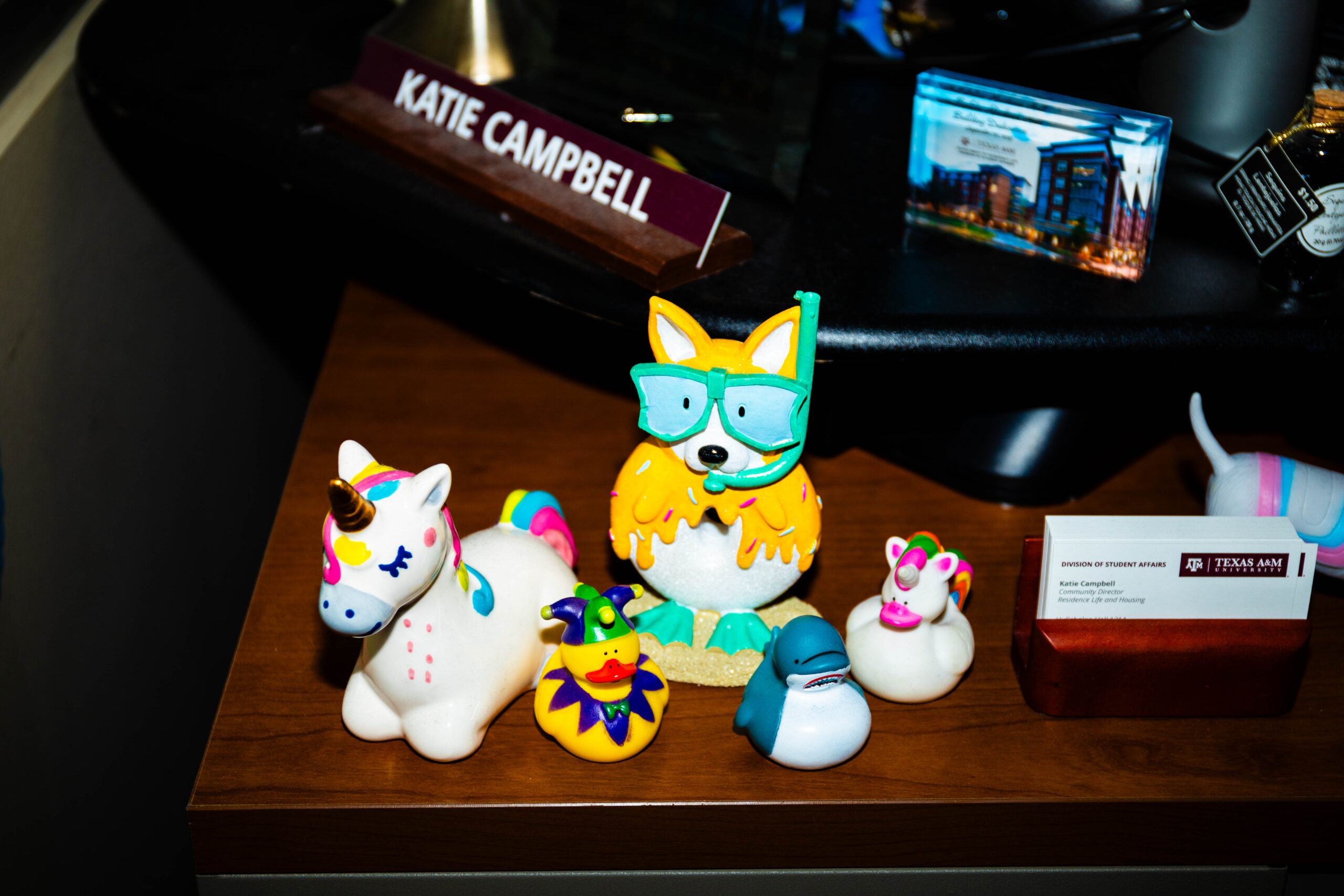 A colorful group of figurines sit on Katie's desk