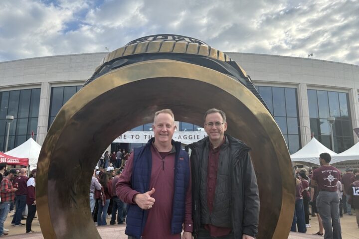 Dr. Patrick Conway '96 with his brother Michael Conway '90 in front of the Aggie Ring statue