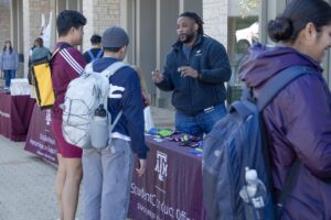 Student connecting with a staff member at a tabling event