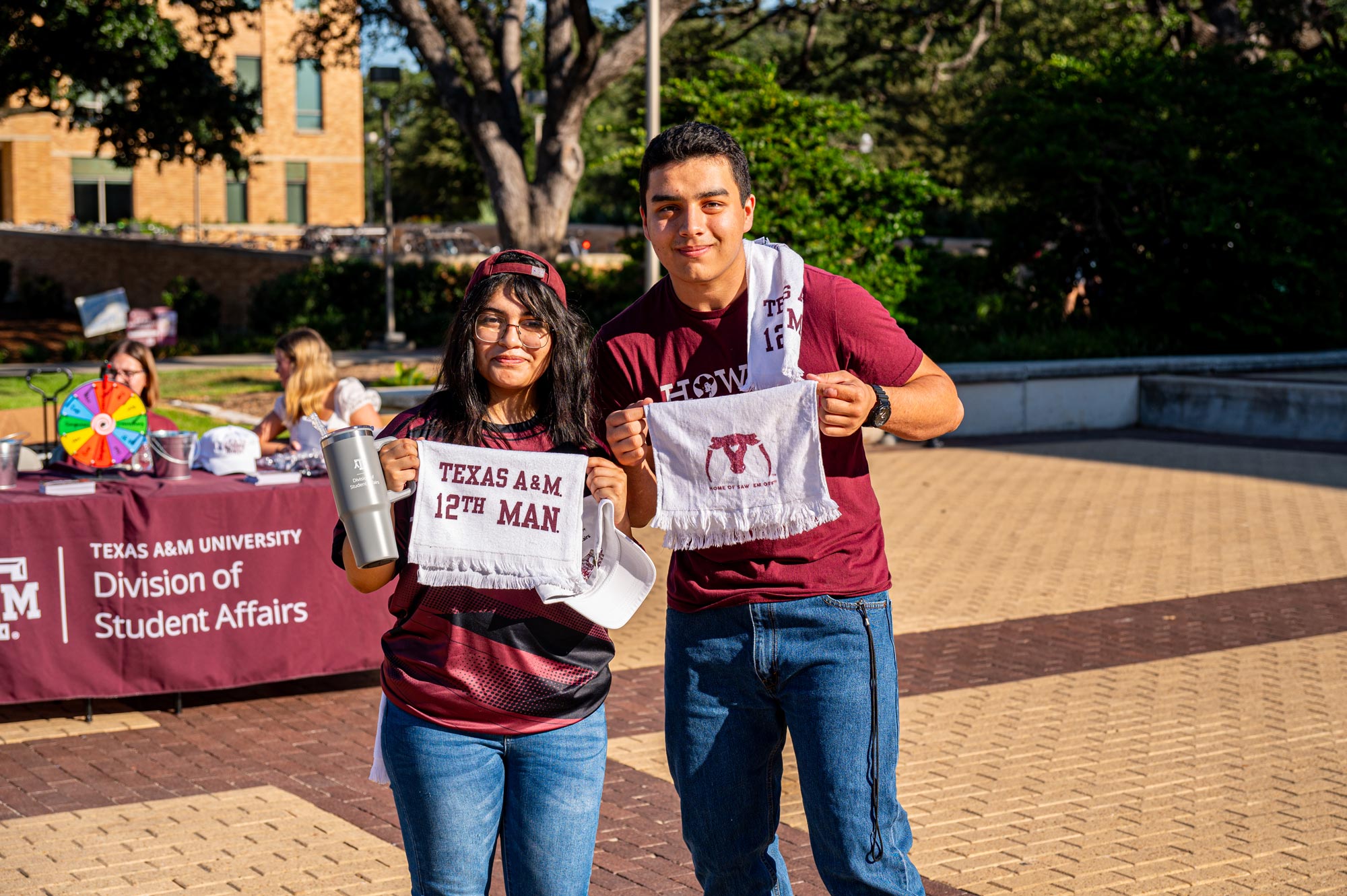 Students holding 12th Man towels at a Division of Student Affairs event in Rudder Plaza