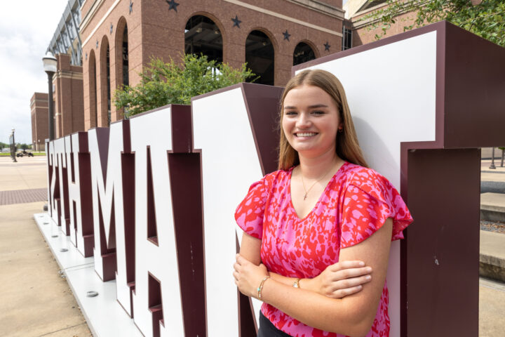 Audri posing in front of the 12th Man letters near Kyle Field Plaza