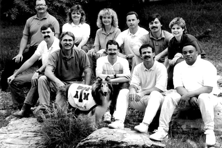 Historical photo of rec sports staff posing with Rev V.