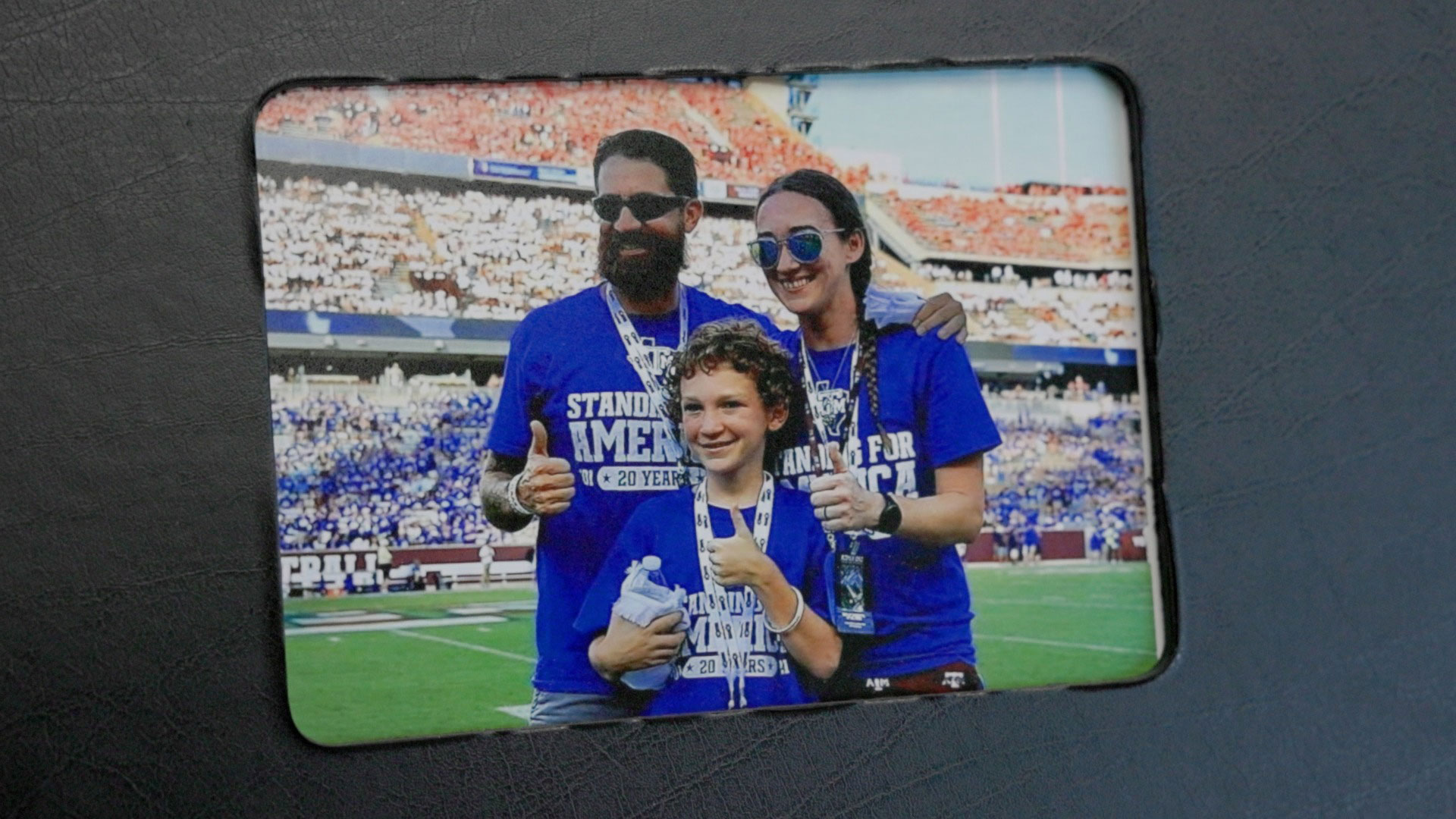 Chris Thompson, Becca Thompson and their son on Kyle Field at the Texas A&M Military Appreciation Game 2020