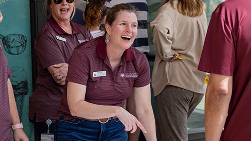 Staff member smiling and talking to another staff member outside of the Moore Family Creamery