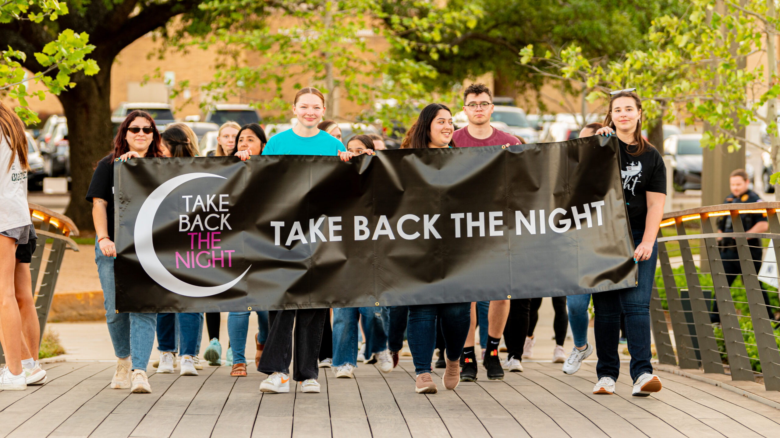 take back the night participants walking through aggie park