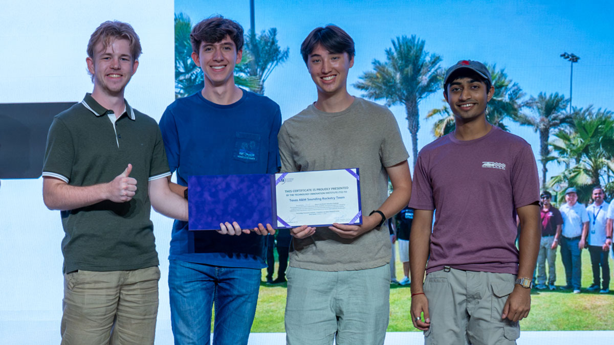 members of SRT standing on a stage receiving an award.
